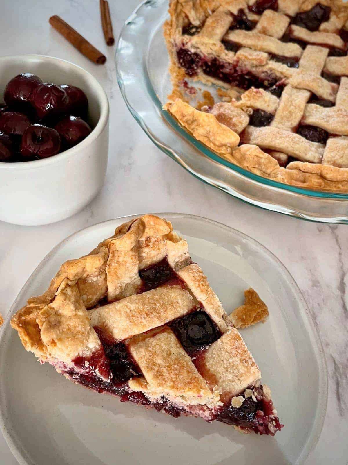 dark cherries in a pie with a classic vegan lattice pie crust.