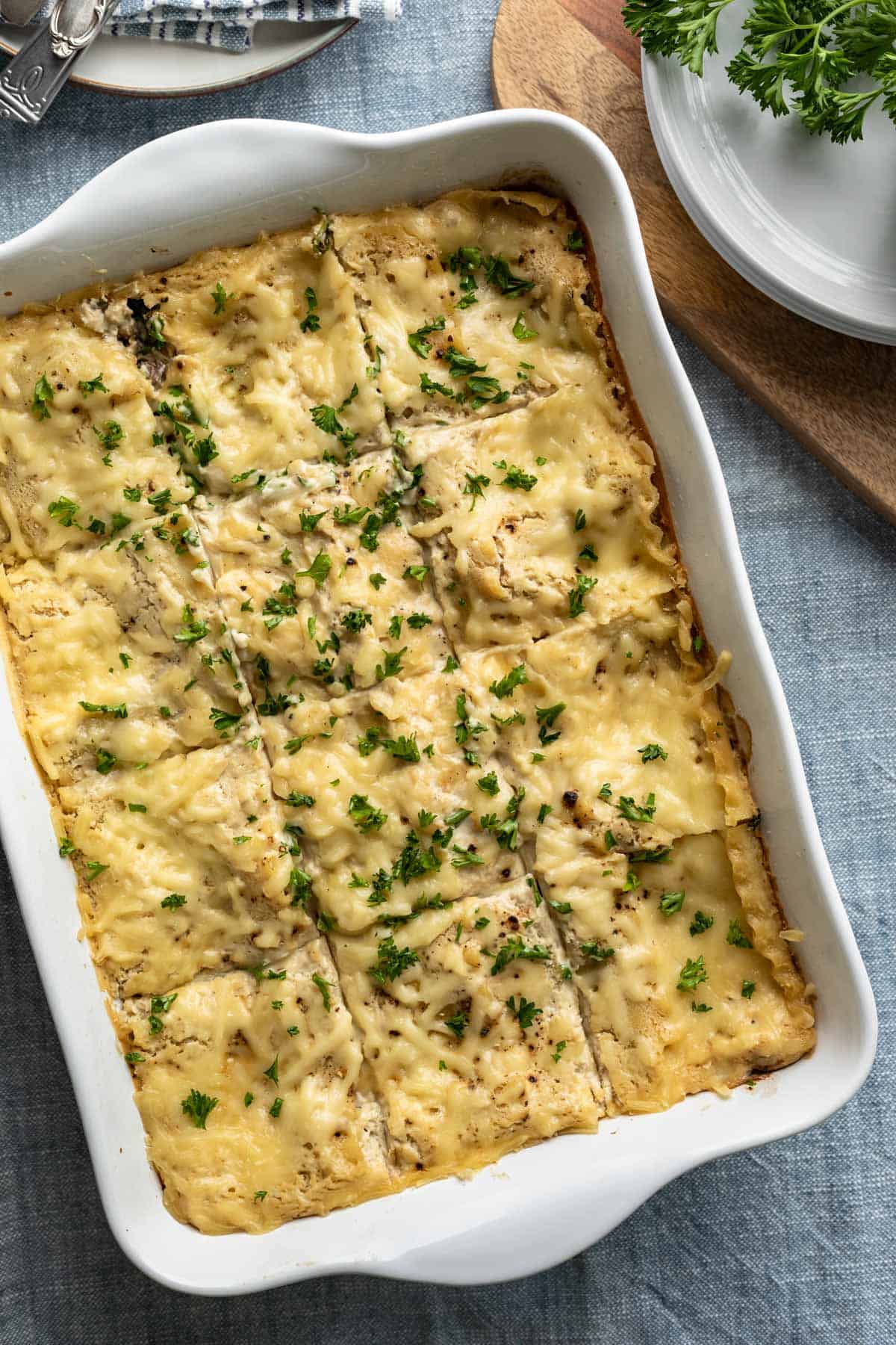 large white casserole dish filled with freshly baked cheesy vegan lasagna.