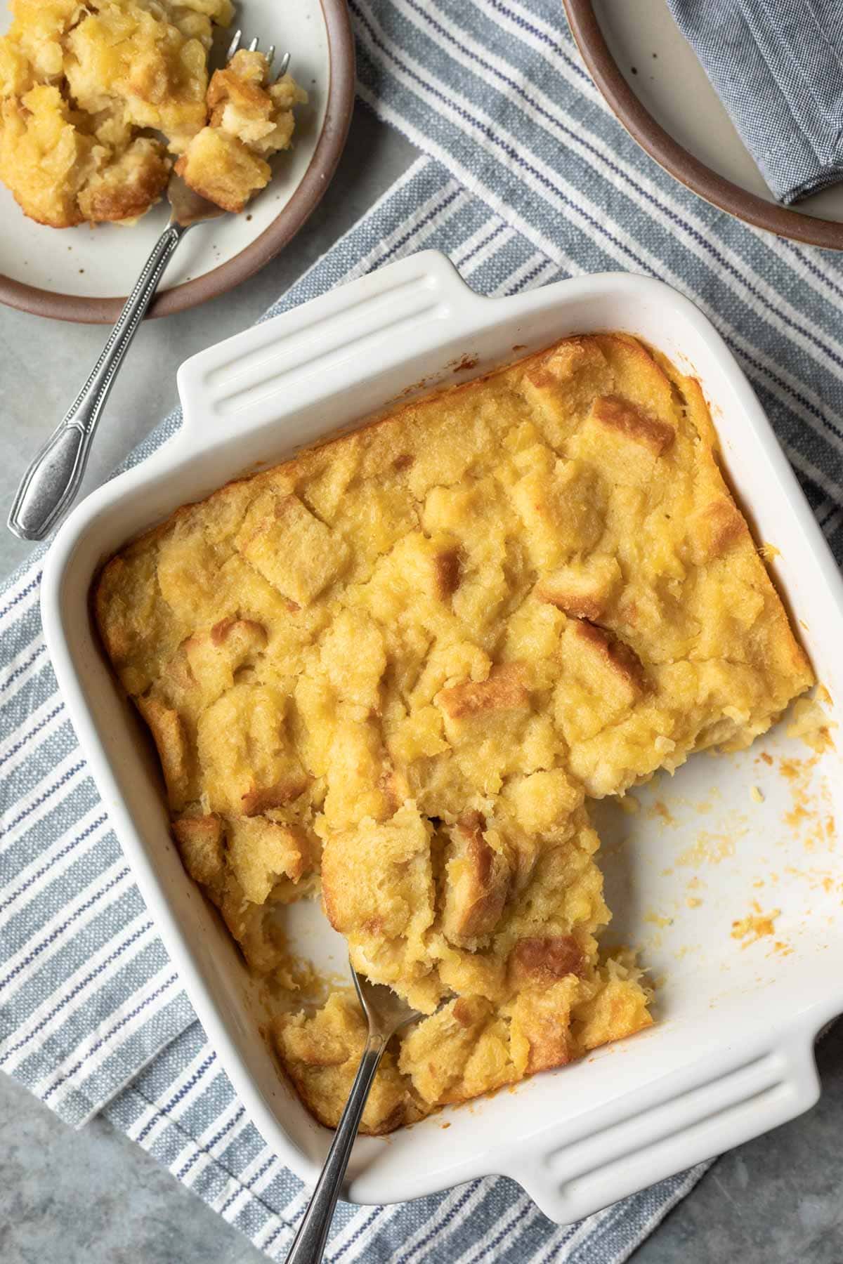 Pineapple stuffing in a white baking dish that rests on a blue striped napkin.