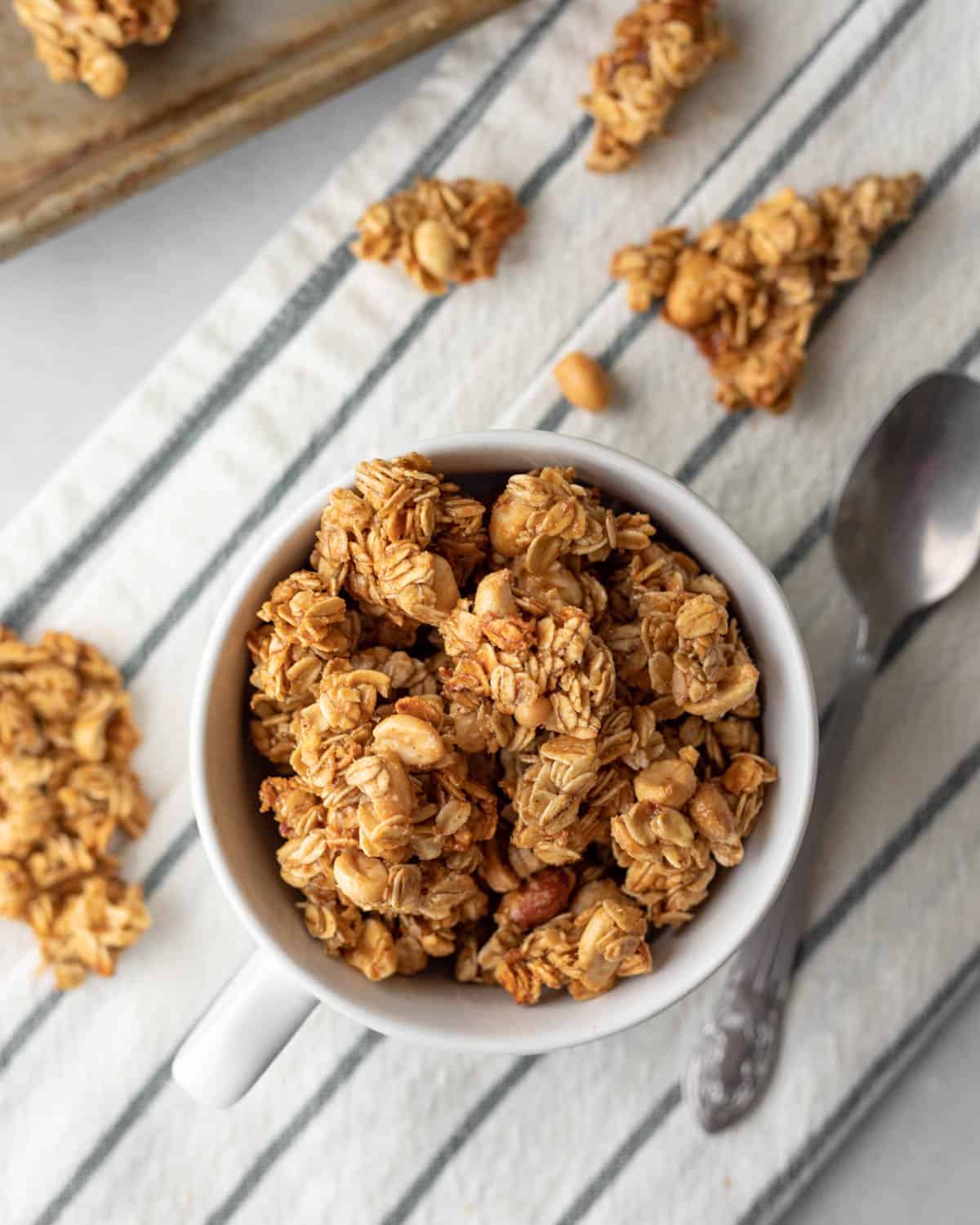 clusters of vegan granola in a white mug.