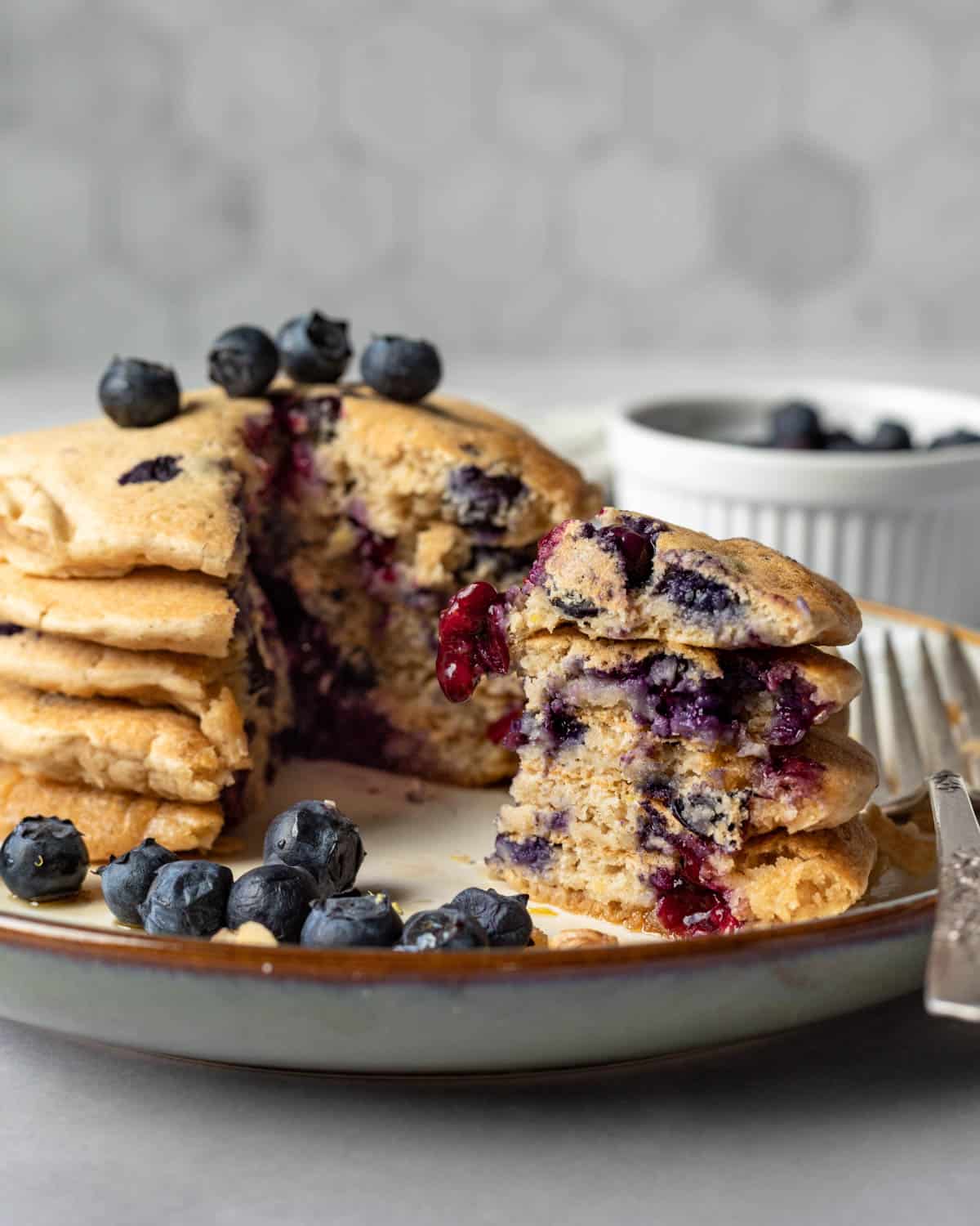 a stack of vegan pancakes made with blueberries and lemon zest.