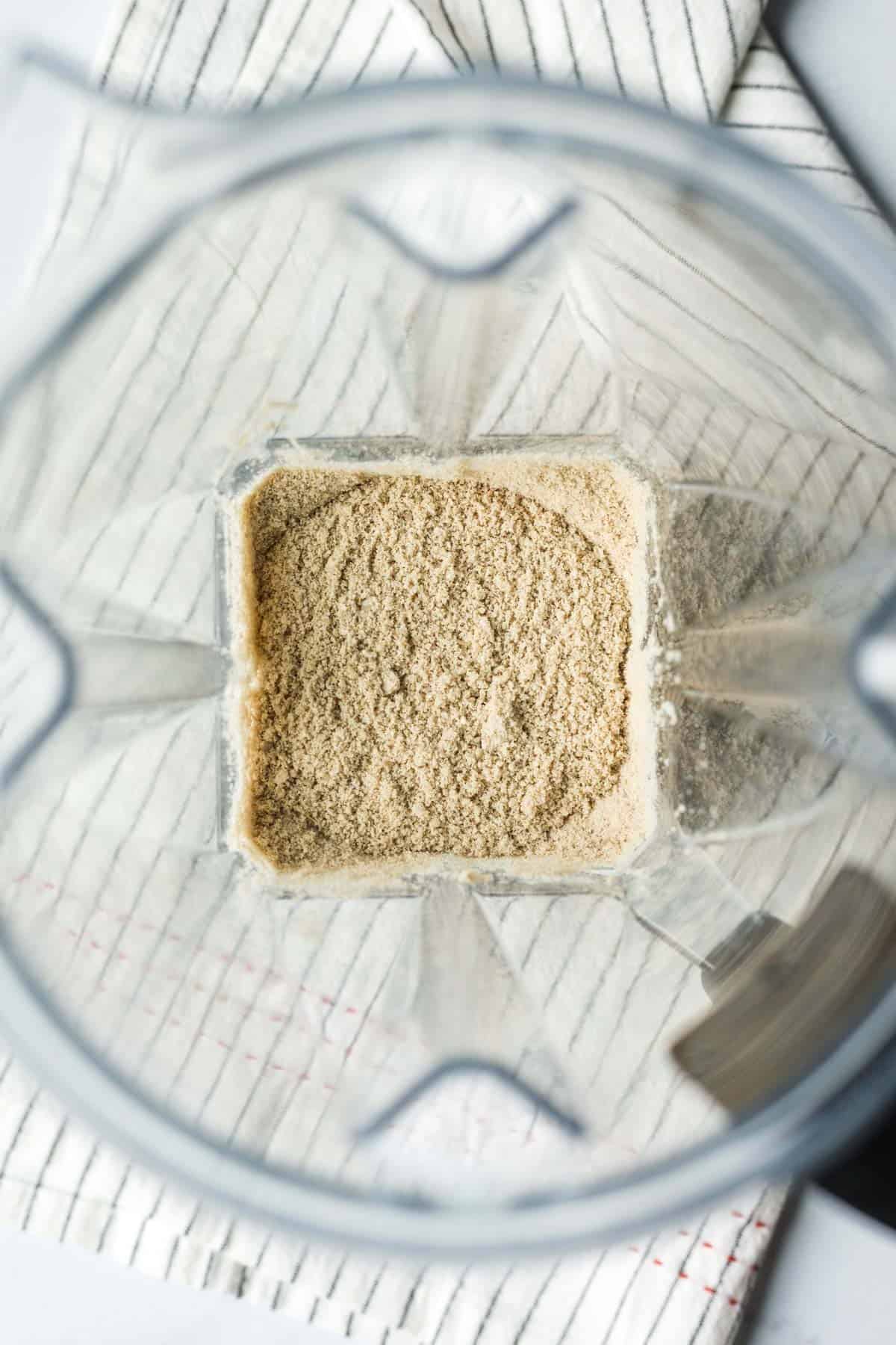 looking down into the blender at the finely textured sunflower flour.