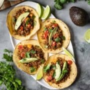 Overhead view of vegan TVP tacos on a white platter.