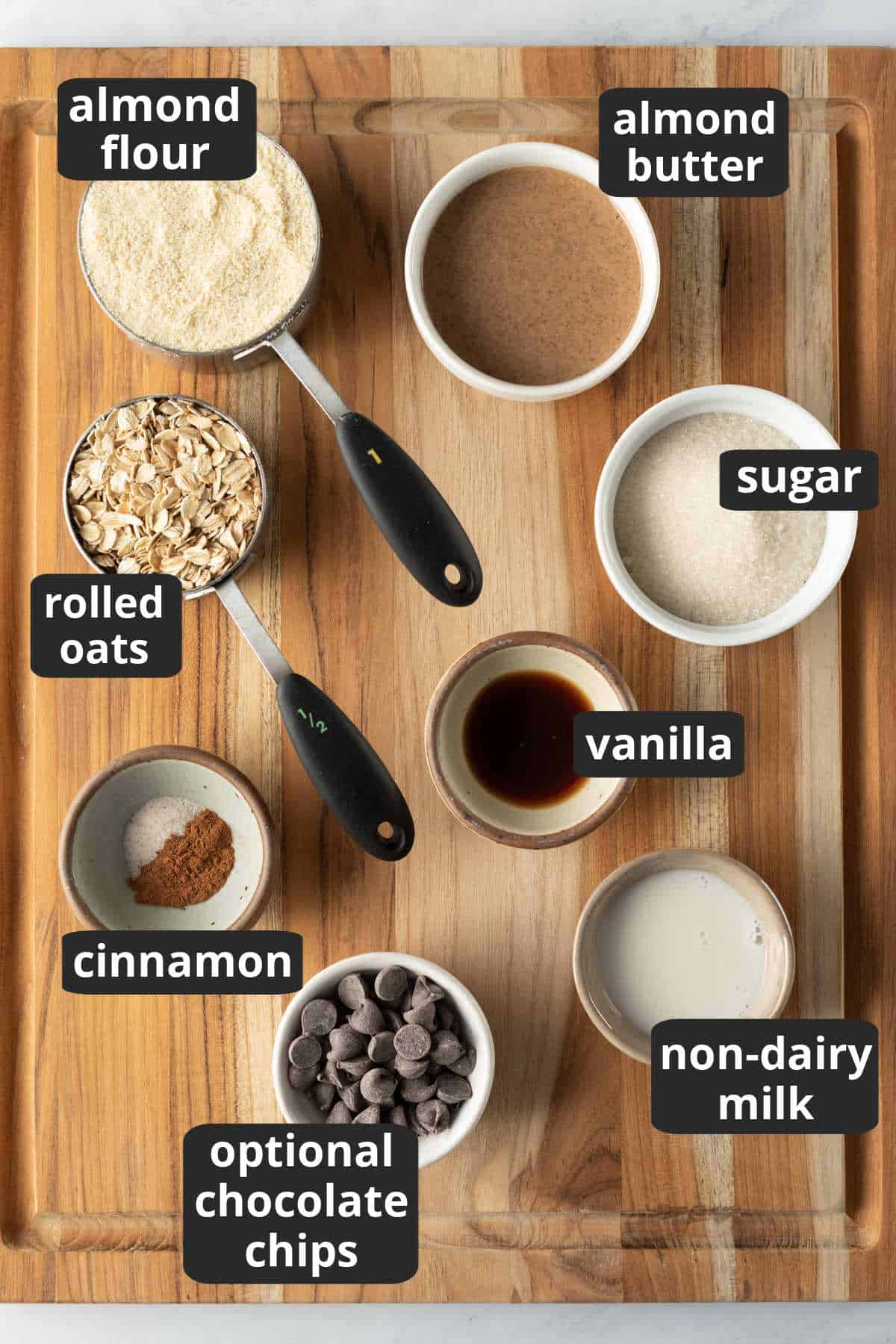 A labeled photo of the 8 ingredients needed to make vegan almond flour oat cookies.
