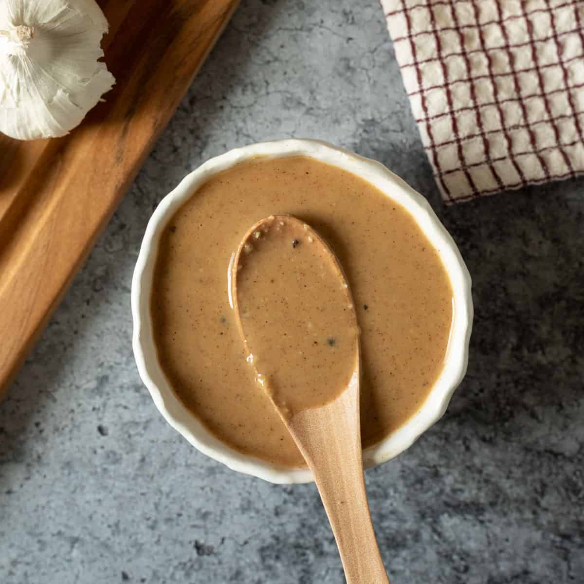 miso dressing and sauce in a small white bowl.