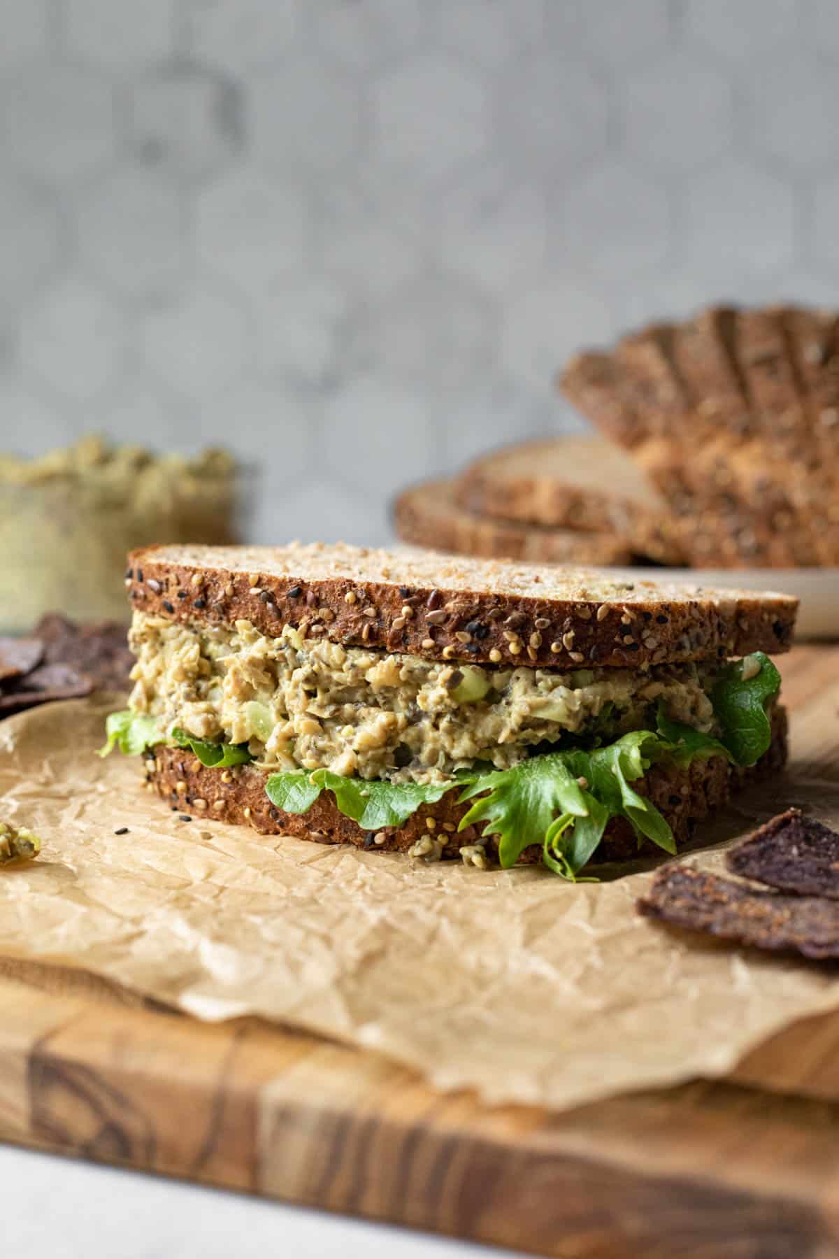 Vegan egg salad sandwich made with whole-grain bread and lettuce.