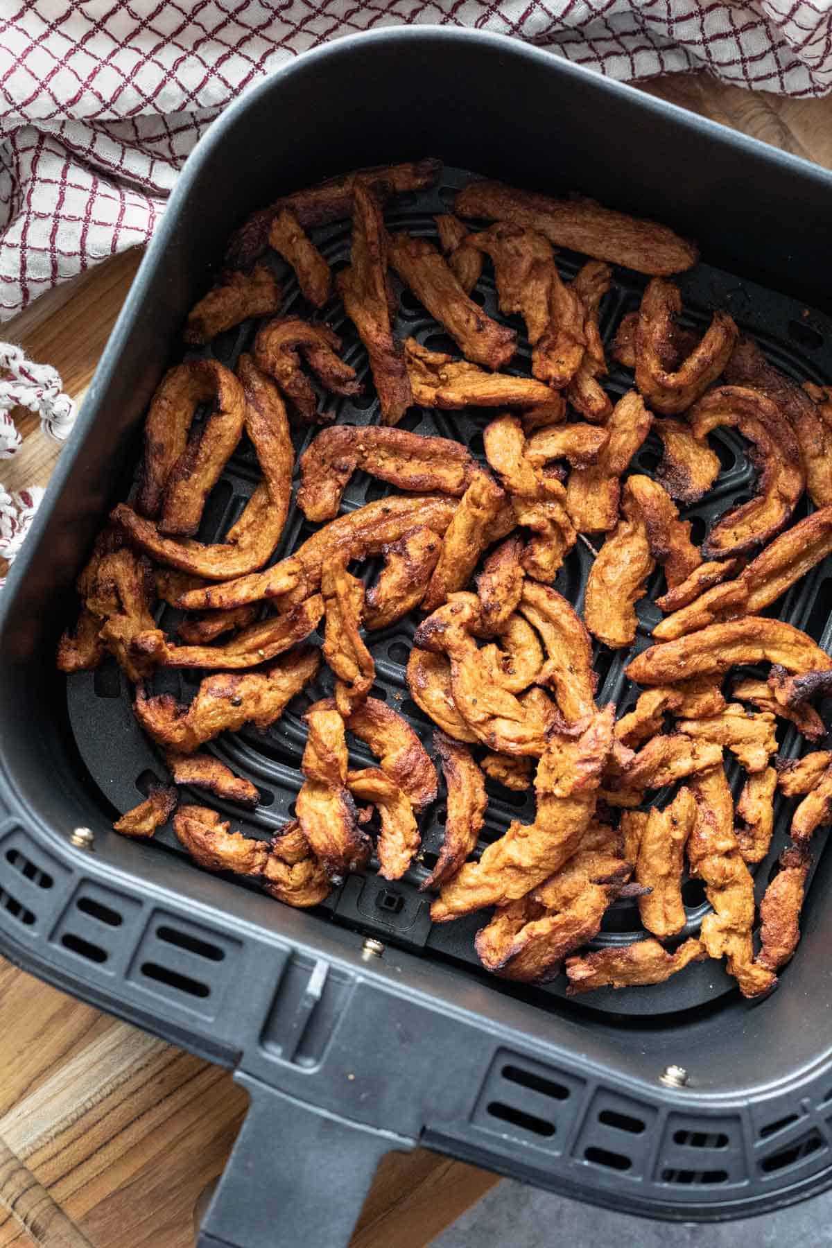 Lightly charred and golden air fried soy curls.