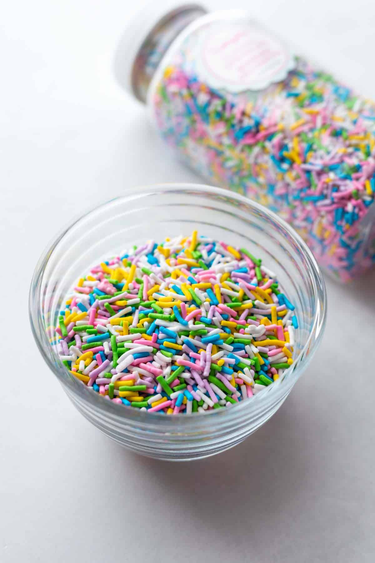 A small glass bowl filled with vegan sprinkles.
