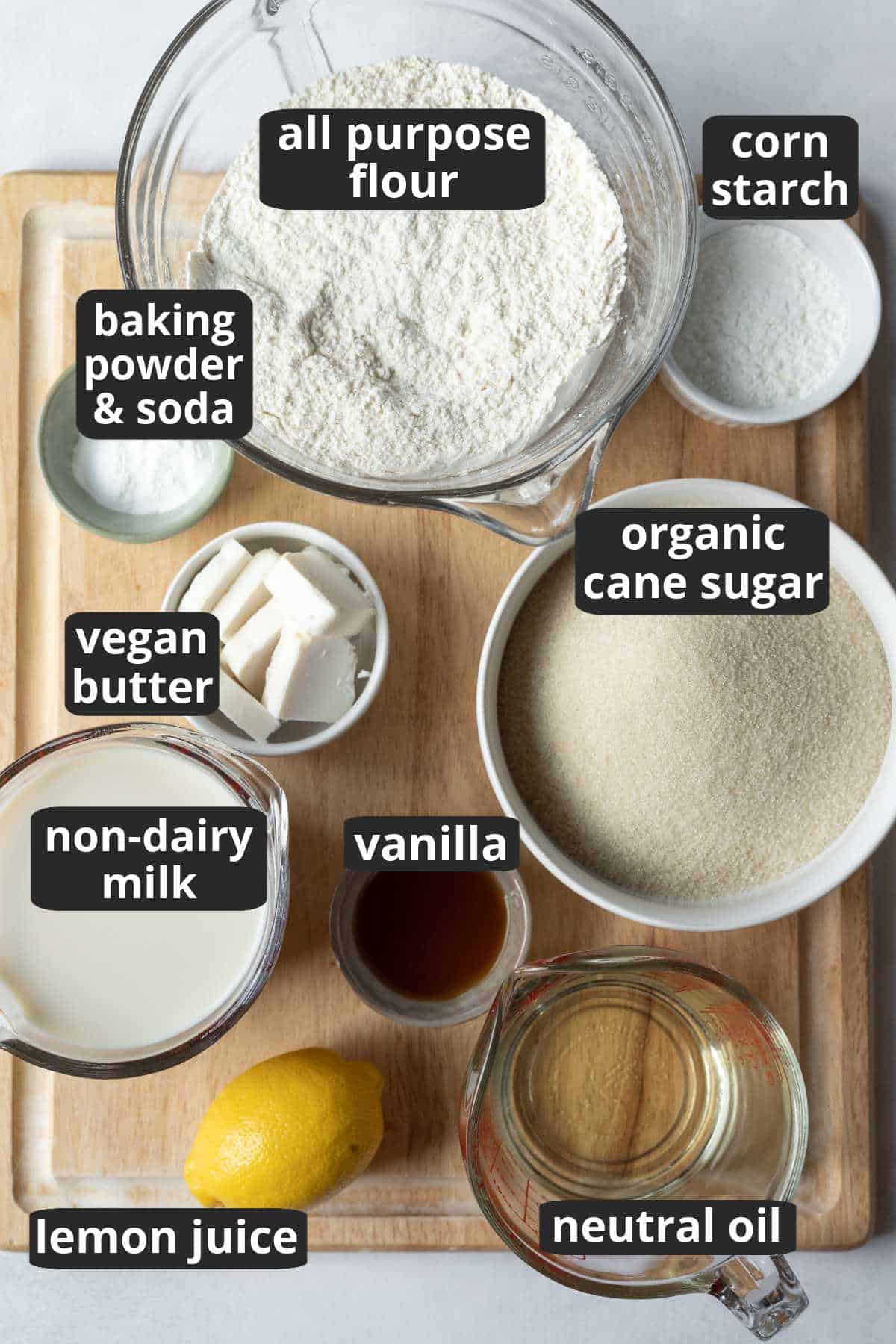 A labeled photo of the ten ingredients needed to make vegan vanilla cake.