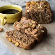 Slices cut from a loaf of homemade banana zucchini bread showing the moist and fluffy texture.