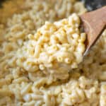 Creamy vegan macaroni and cheese inside a large black Crockpot.