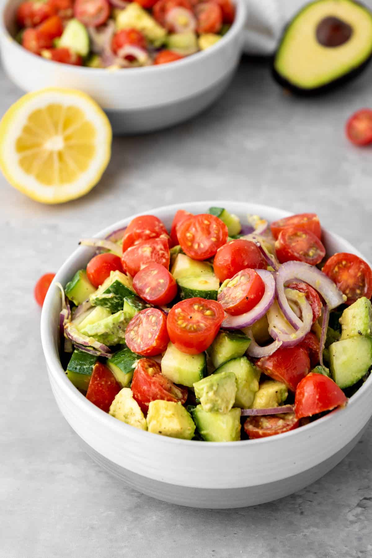 Bright and colorful bowl of creamy avocado cucumber salad.
