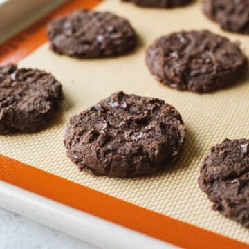 Chocolate chickpea cookies on a baking sheet.