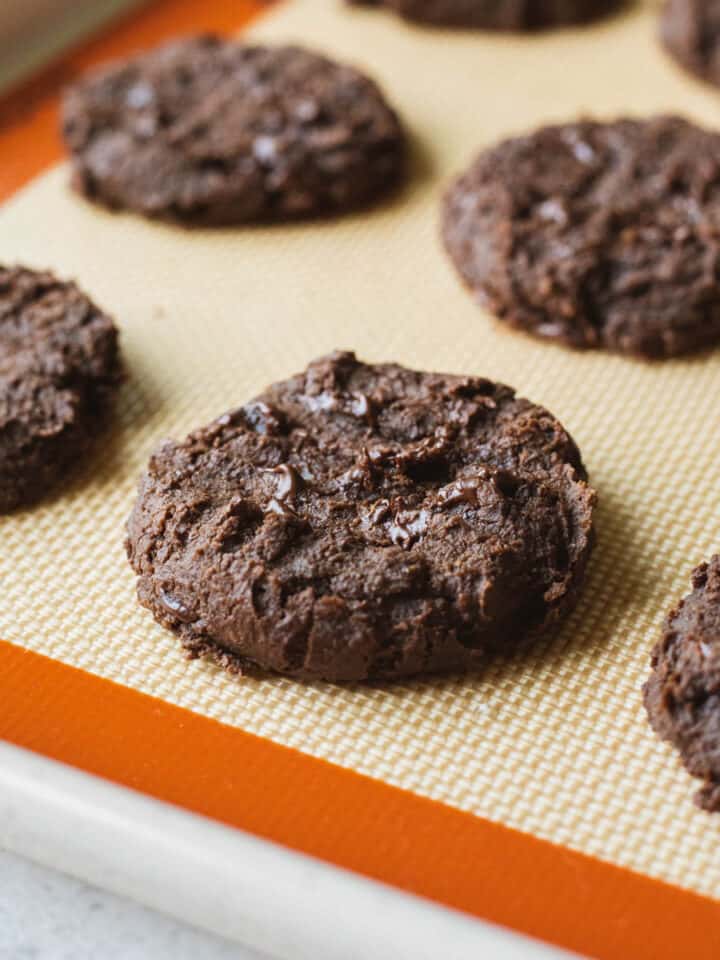 Chocolate chickpea cookies on a baking sheet.