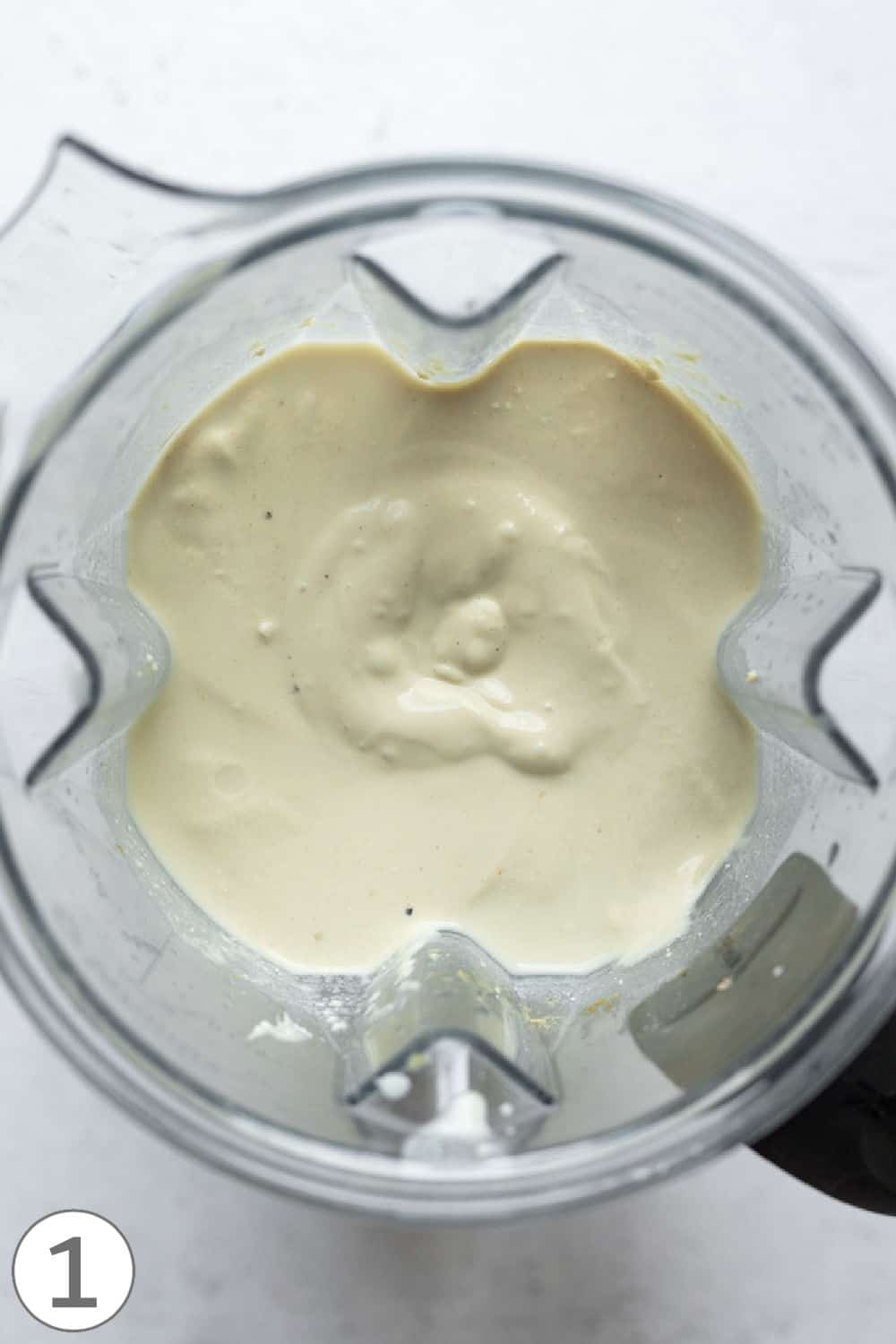 Looking inside a blender at the blended vegan egg mixture.