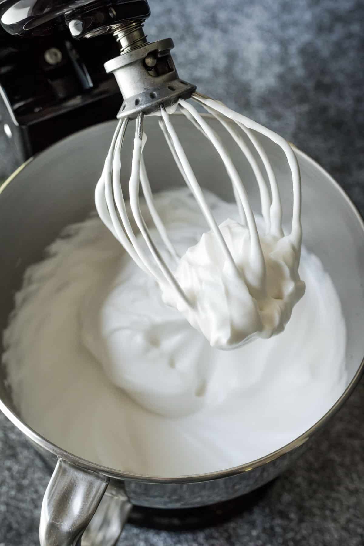 Fluffy aquafaba vegan whipped cream in a stand mixer bowl.