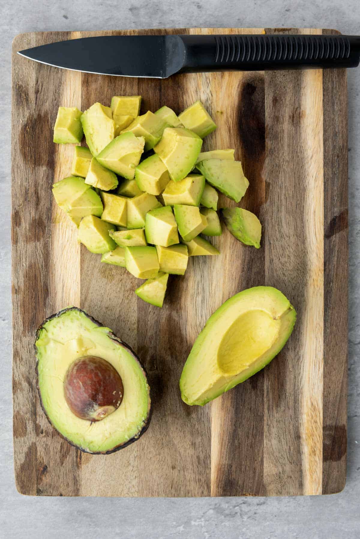 Cutting avocado into chunks for salad.