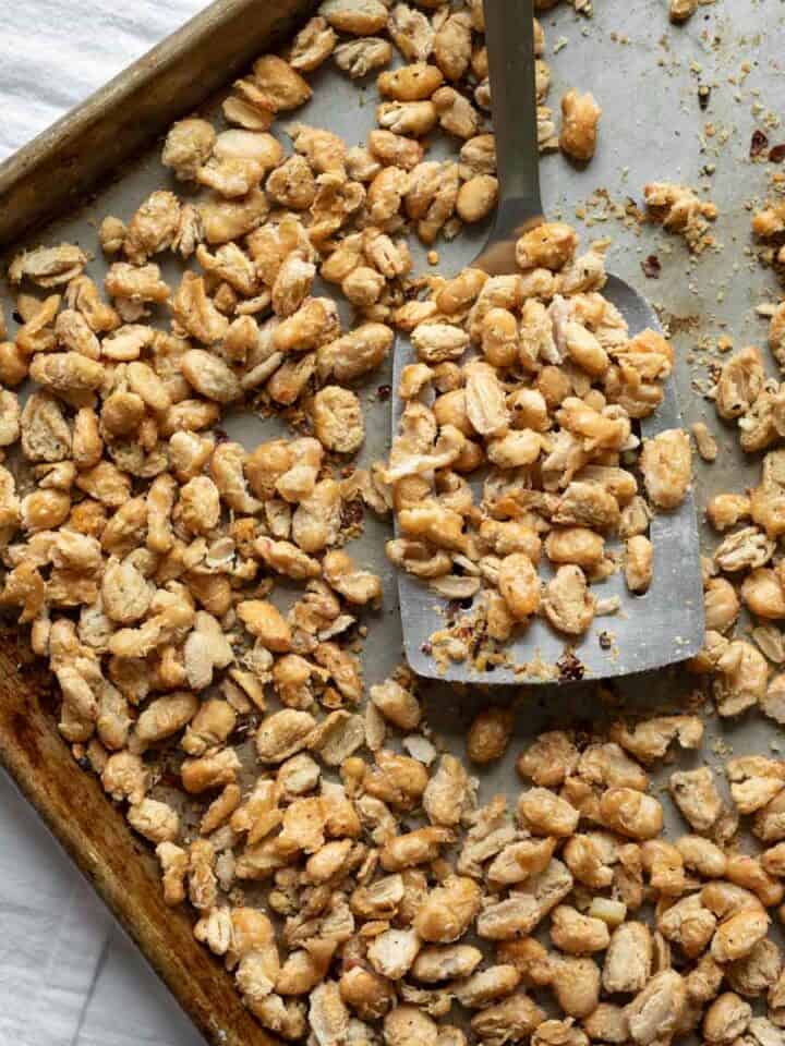 Crispy roasted cannellini beans spread out on a sheet tray.