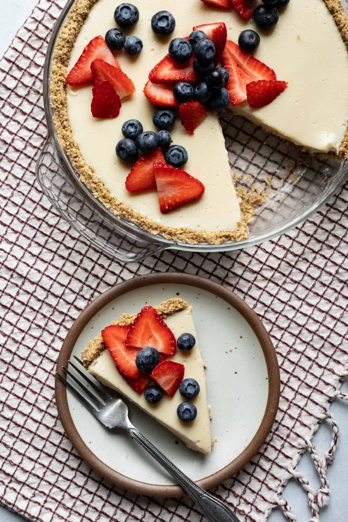 A creamy vanilla pie filling in oatmeal pie crust topped with berries.