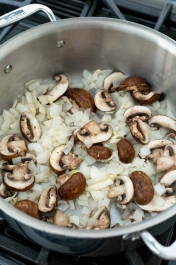 Sauteing onion and mushrooms for potato stew.
