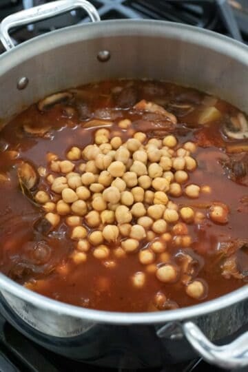 Adding chickpeas to the stew during the last few minutes of cooking.