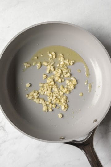 Sauteing garlic in olive oil.