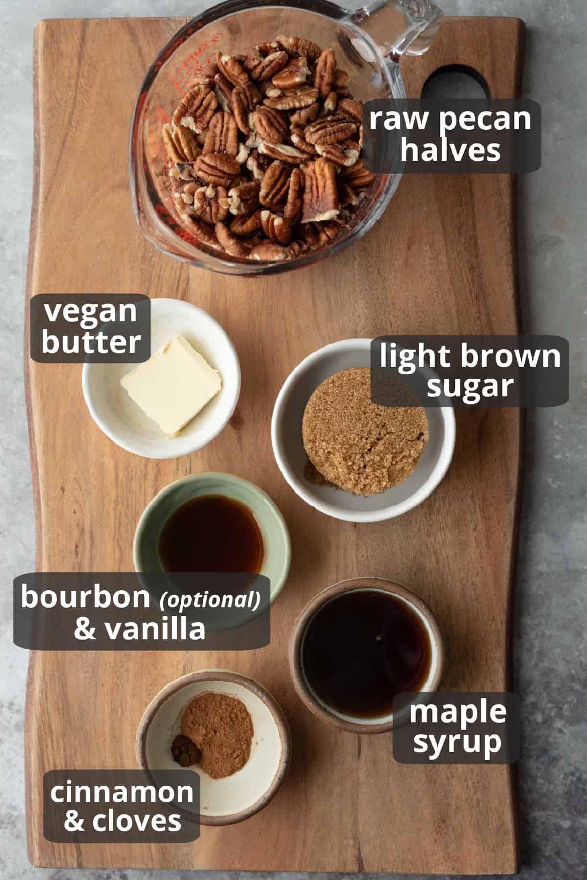 A labeled photo of the 7 ingredients needed to make vegan candied pecans with bourbon and cinnamon.