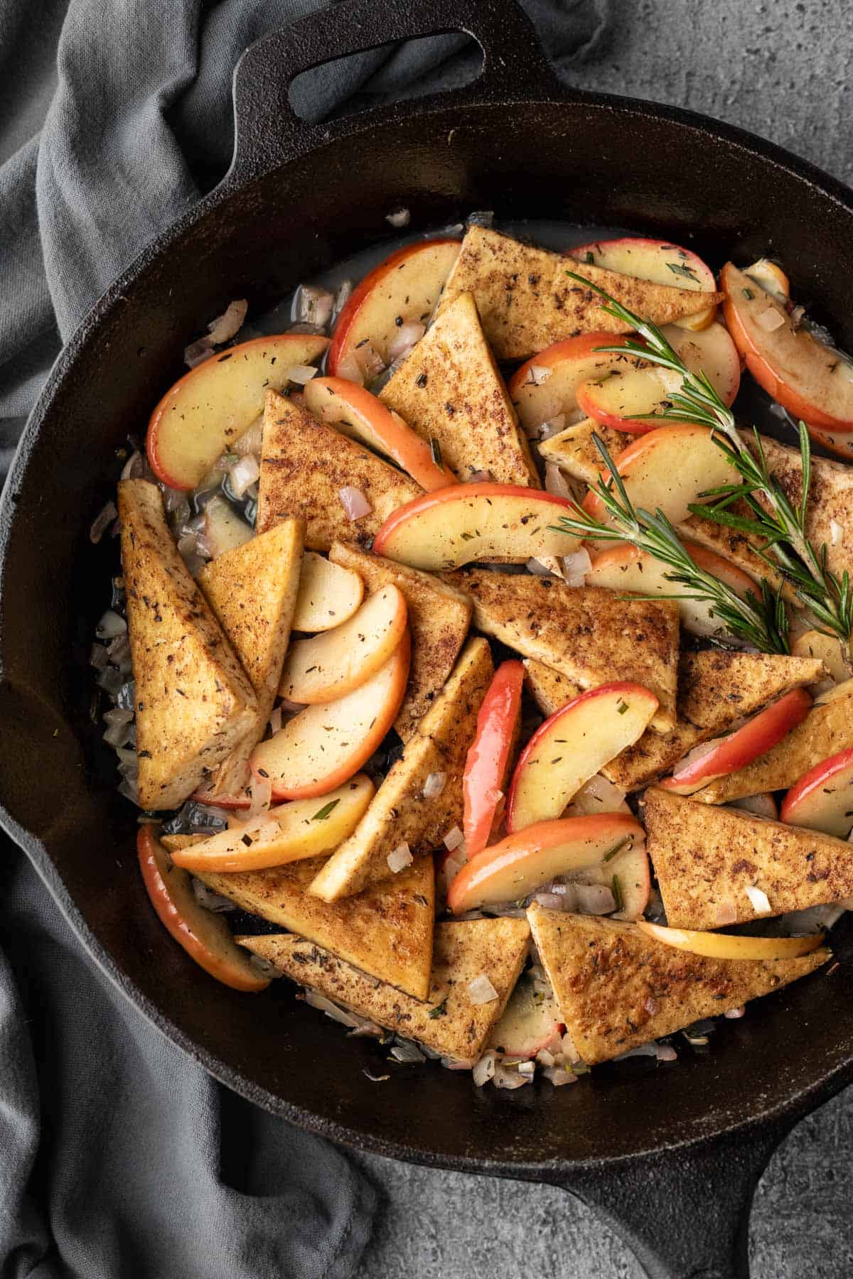 Close up of apple glazed tofu in a large skillet.