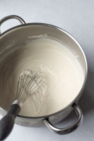 Heating the cheesecake filling on the stovetop.