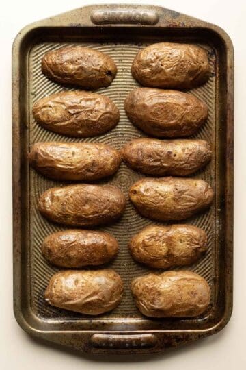 Making potato skins involves baking the hollowed out skins cut-side down.