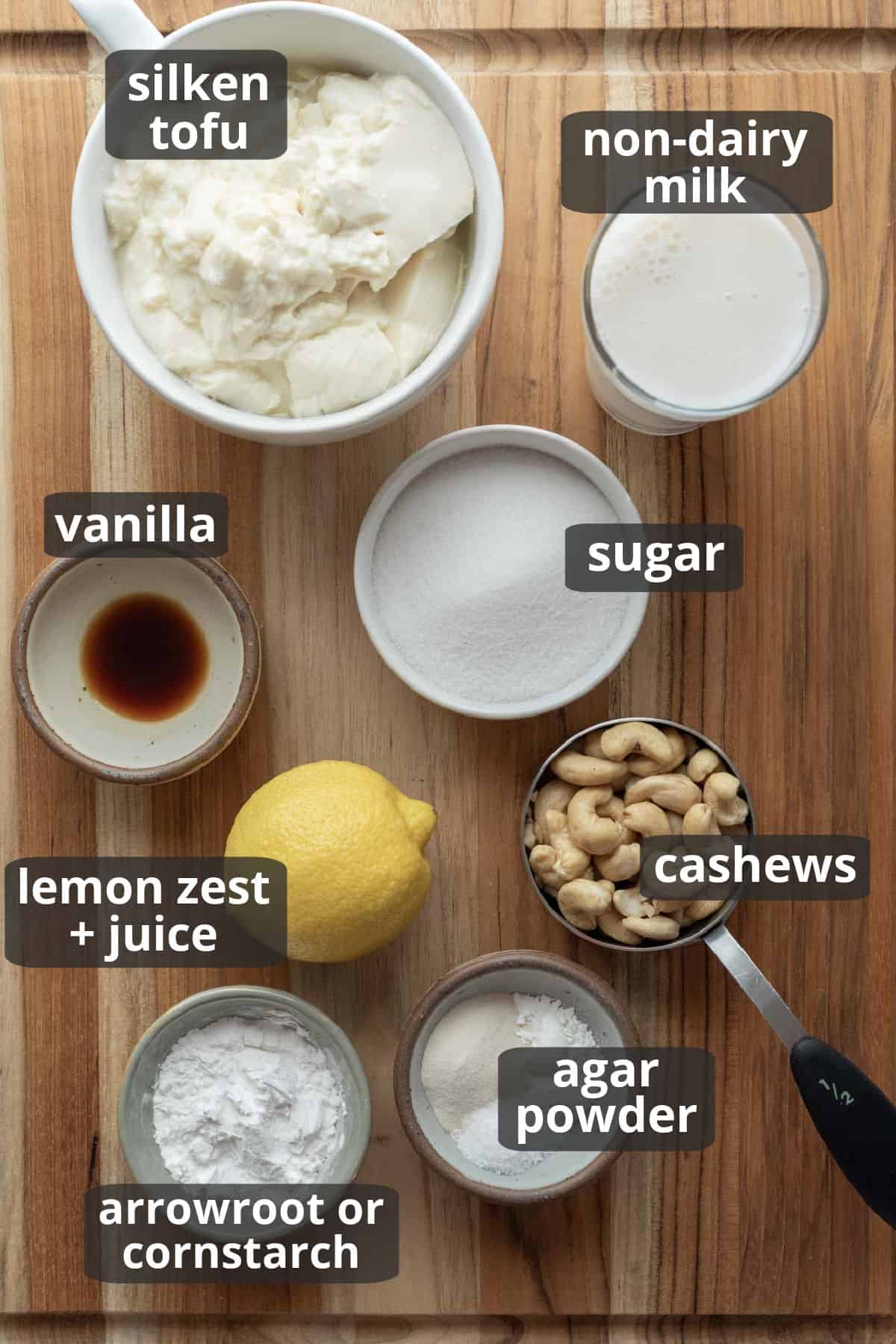 A labeled photo of the 7 ingredients needed to make tofu cheesecake.