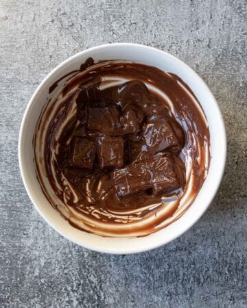 Melting dark chocolate in a bowl in the microwave.