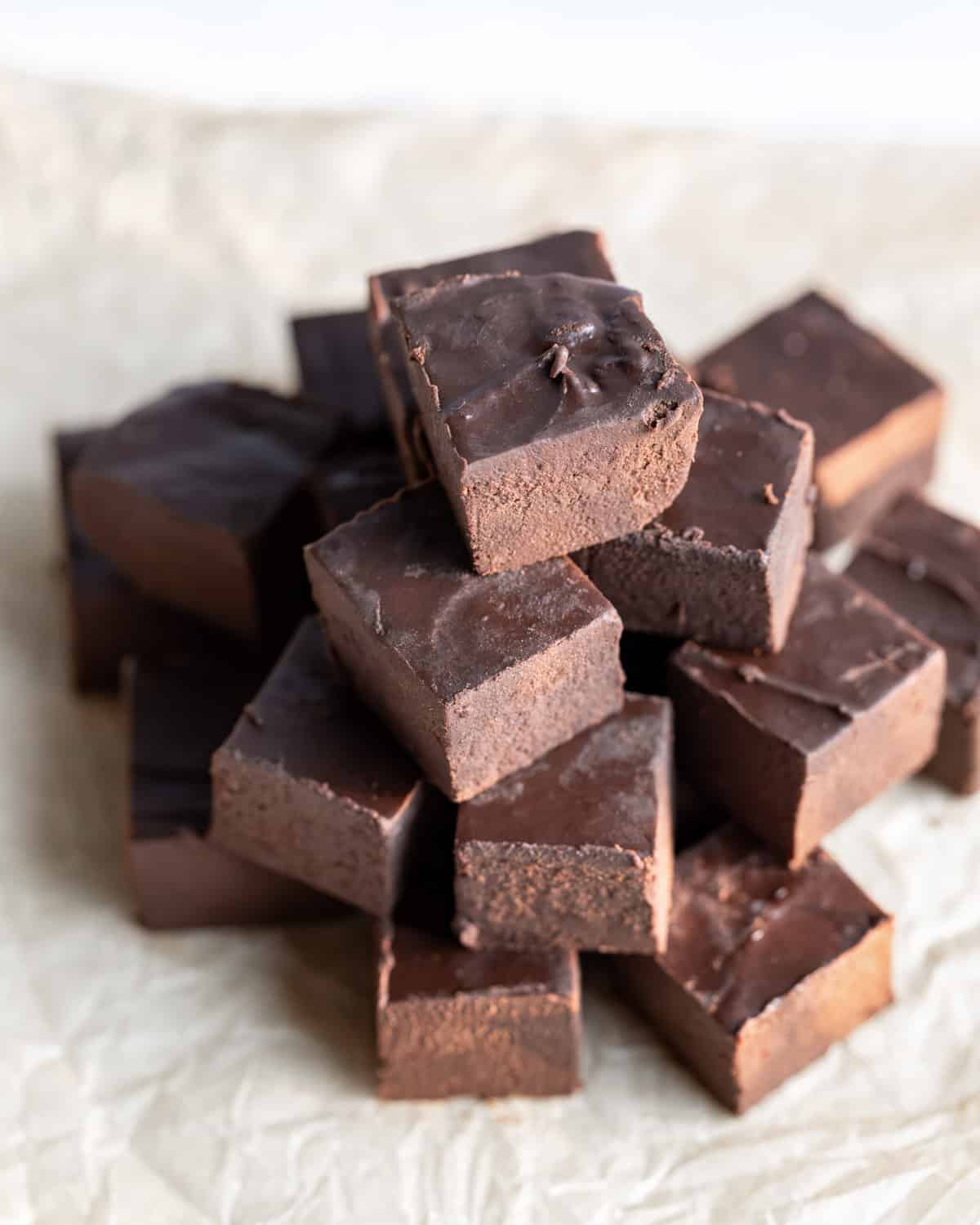 A stack of vegan 2-ingredient fudge that has been cut into squares.