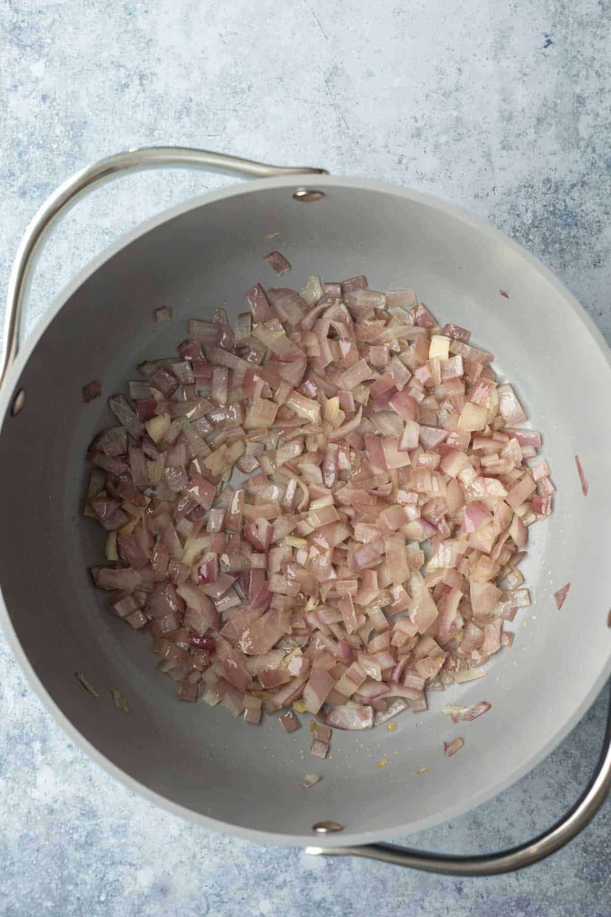 sautéing onion in a soup pot.
