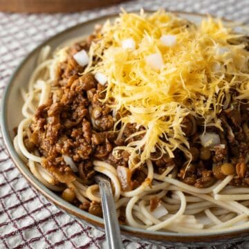 close-up of vegan Cincinnati chili over spaghetti in a bowl.