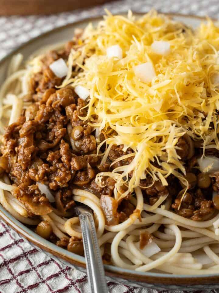 close-up of vegan Cincinnati chili over spaghetti in a bowl.