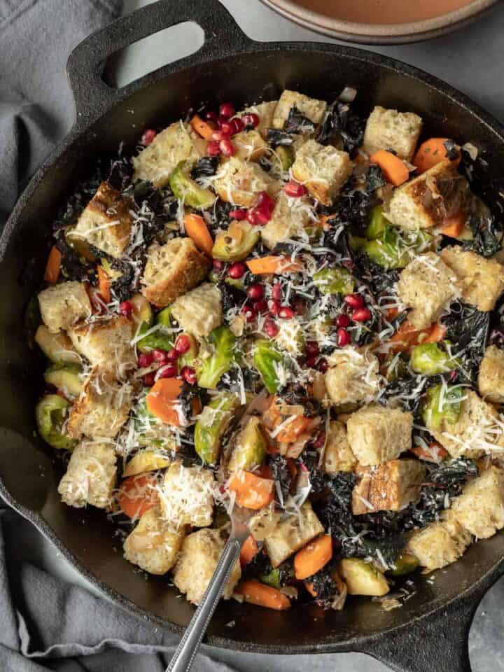 close-up overhead of winter panzanella salad in a cast iron pan.