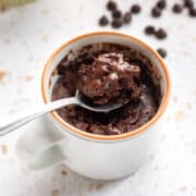 Spooning up a bite of chocolate mug brownie.
