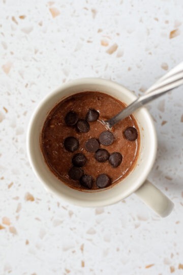 Brownie batter stirred together in a mug.