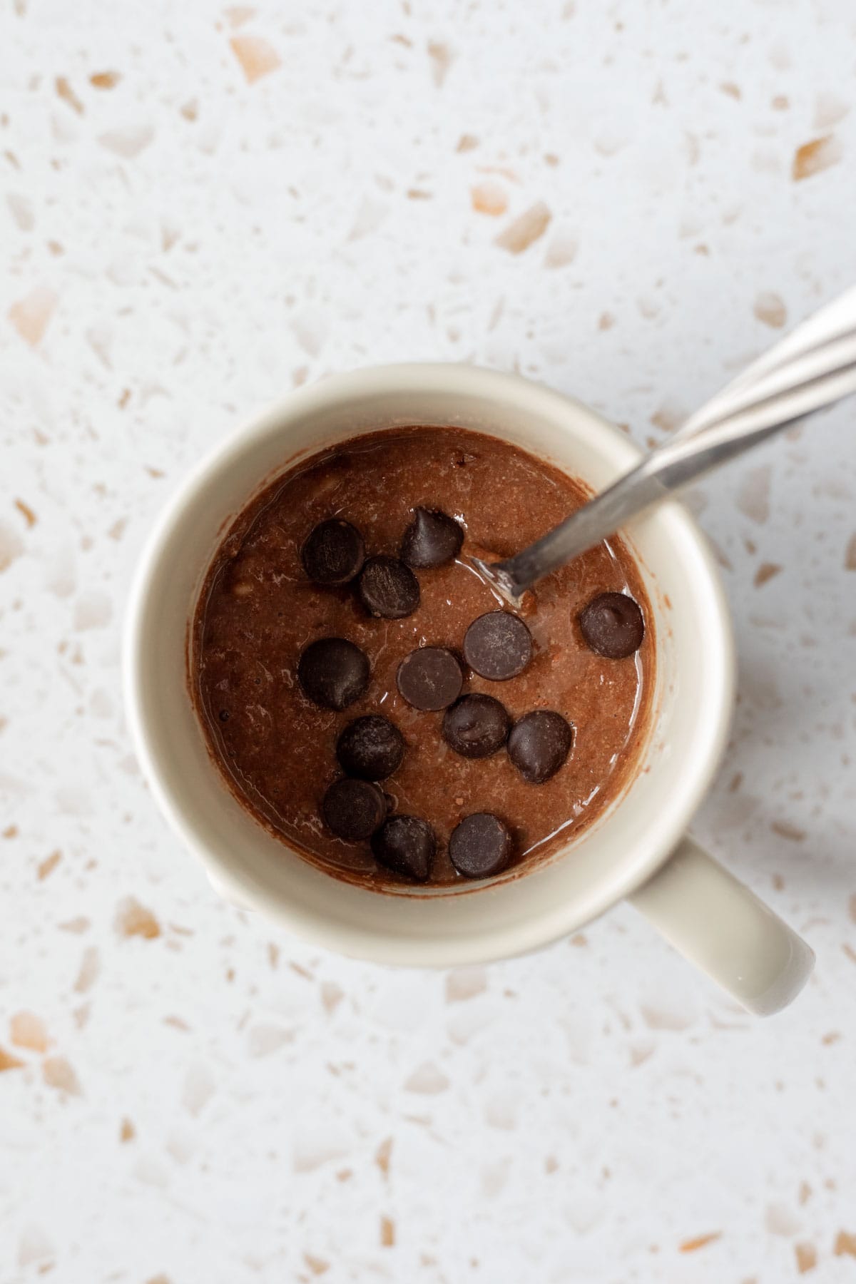 Brownie batter stirred together in a mug.