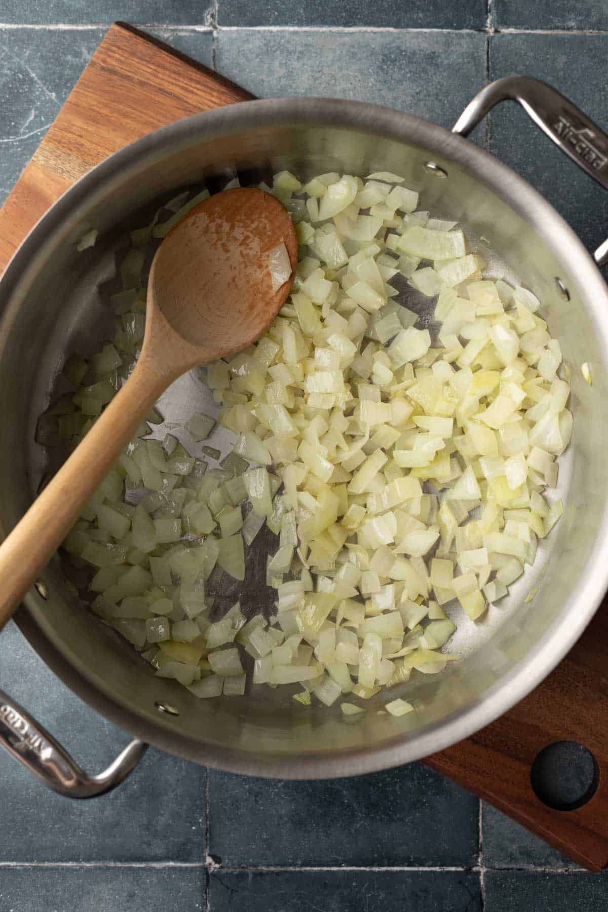 Sauteing onion in oil to create the base of the soup.