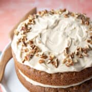 Almond flour frosting on a two-layer vegan carrot cake.