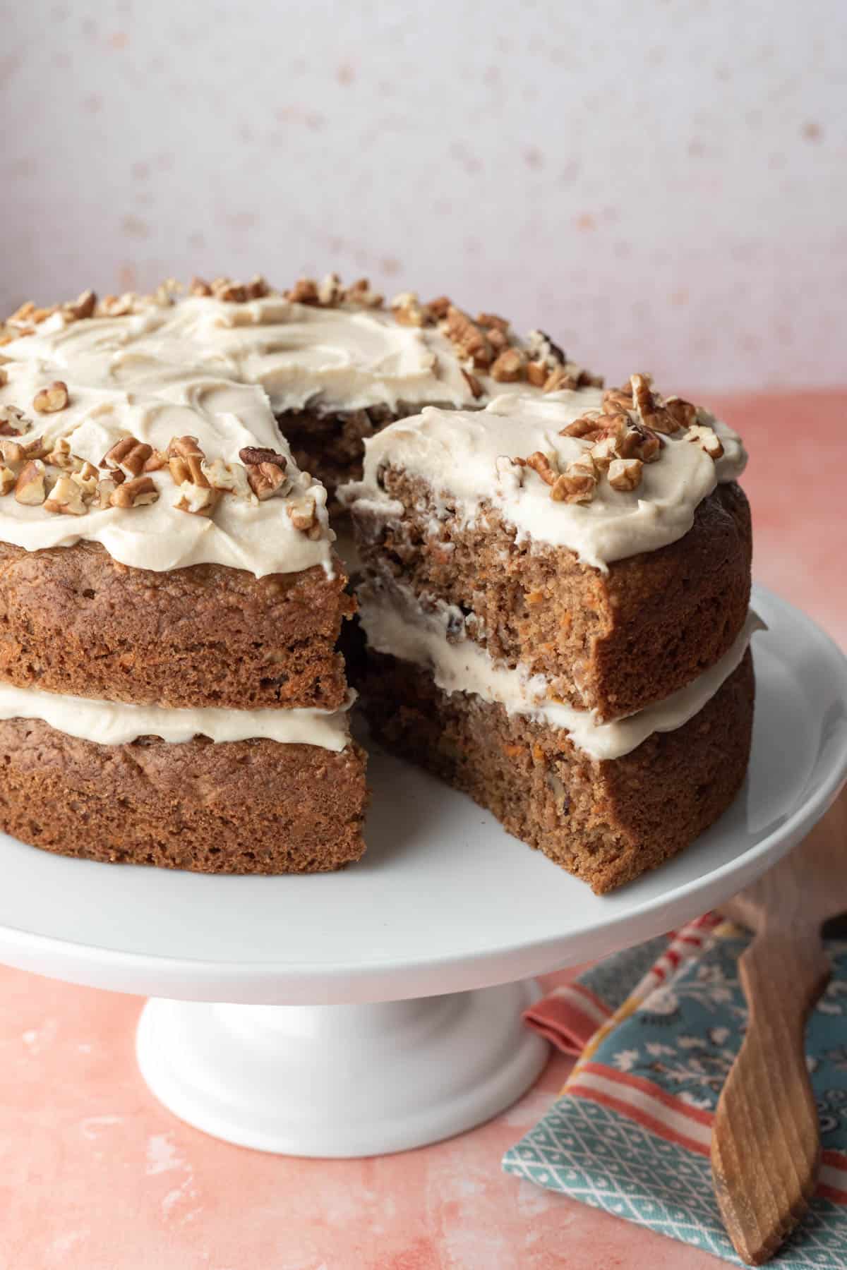 Two-layer vegan carrot cake with almond-based cream cheese frosting.