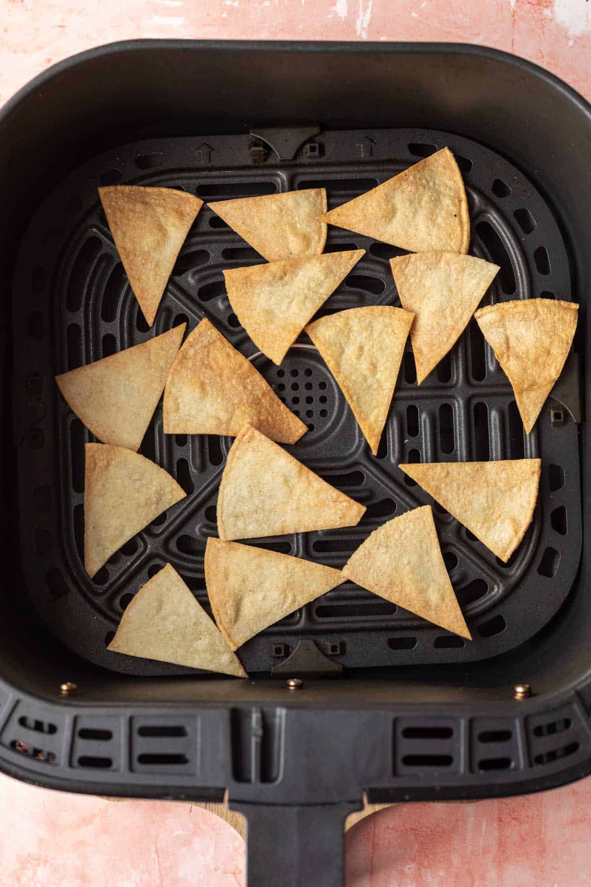 tortilla chips after cooking in the air fryer basket.