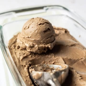 Close up of a scoop of vegan date ice cream made with sunflower seeds.