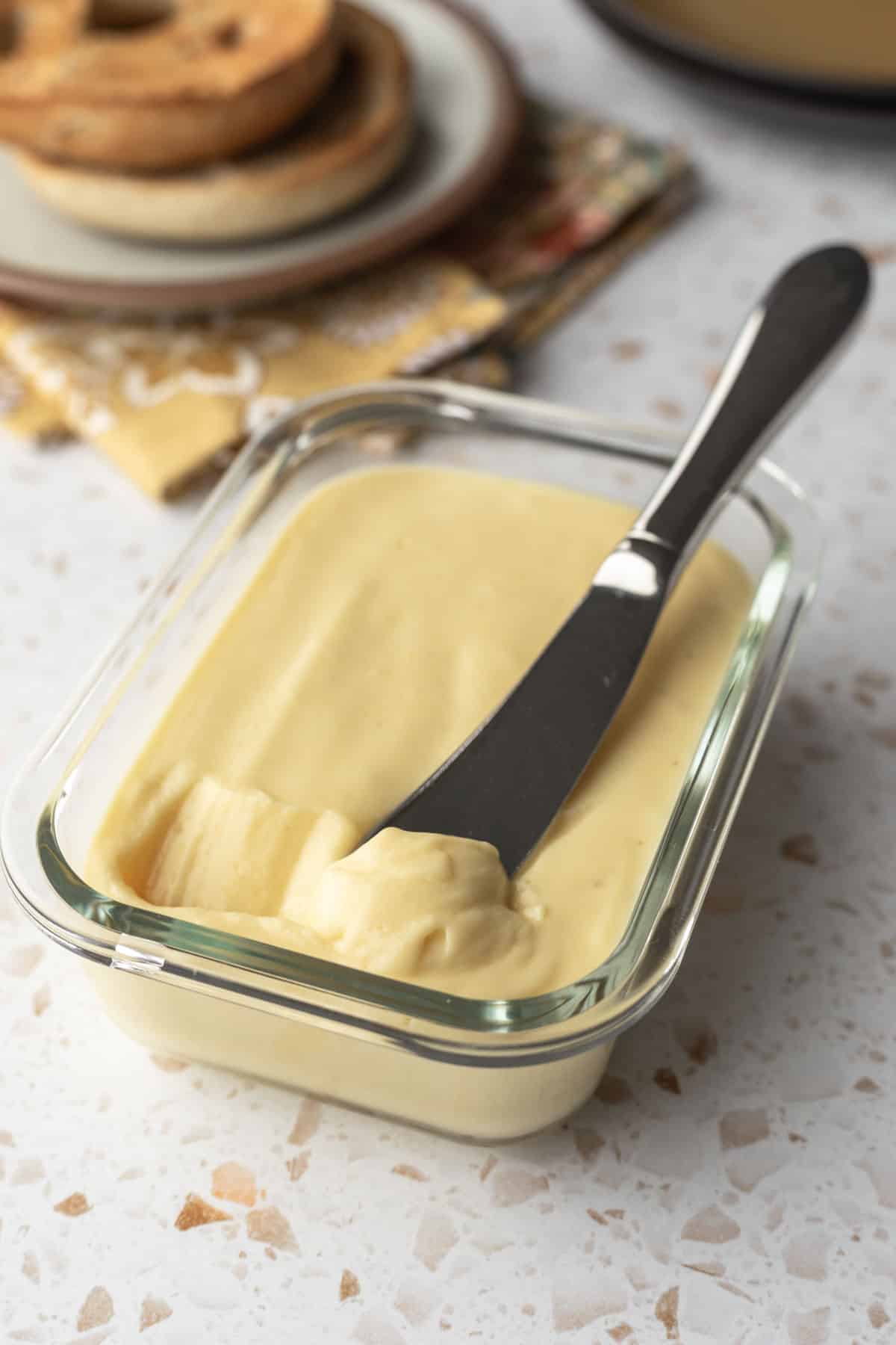 oil-free vegan butter in a glass container with a knife for spreading.