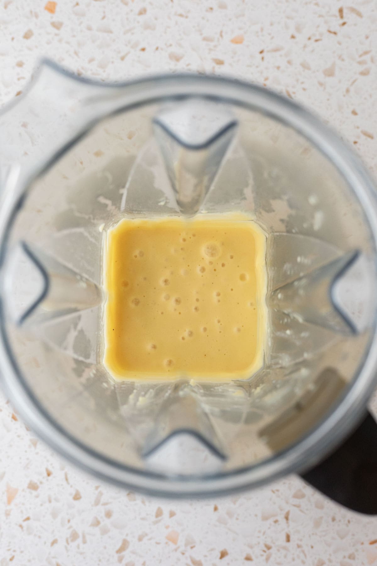 overhead shot of the creamy butter mixture in the blender after blending.