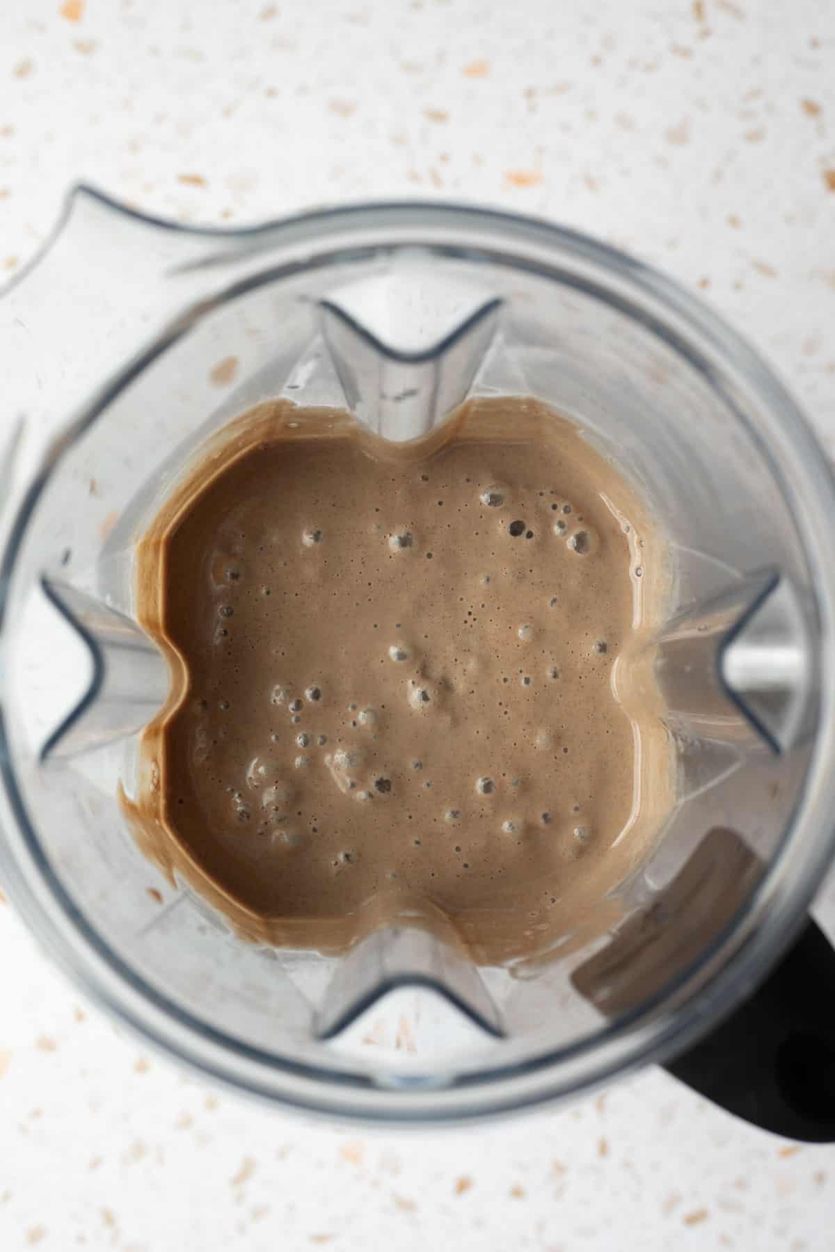 Looking inside the blender jar after blending the date ice cream base.