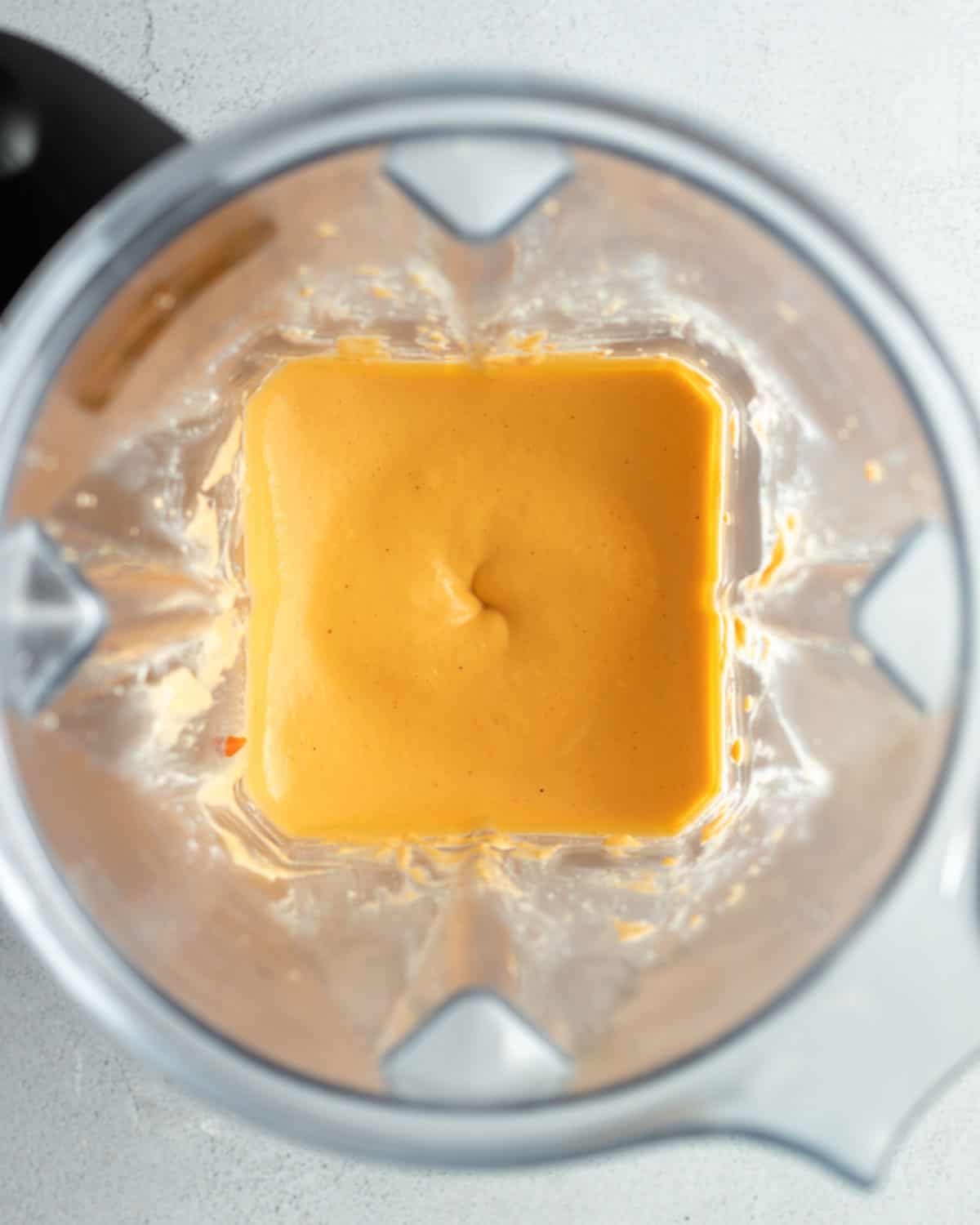 Bright orange cashew cheese mixture blended until smooth and creamy.