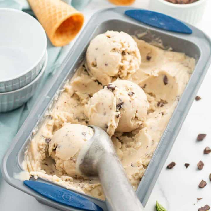 scooping vegan mint chip ice cream out of a loaf pan.